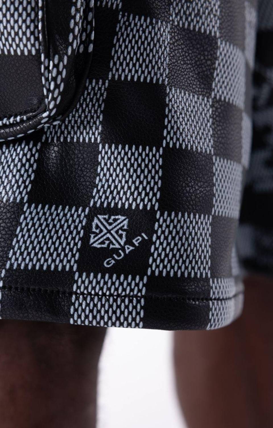 Checkerboard texture detail on Guapi Obsidian Black Leather Shorts.