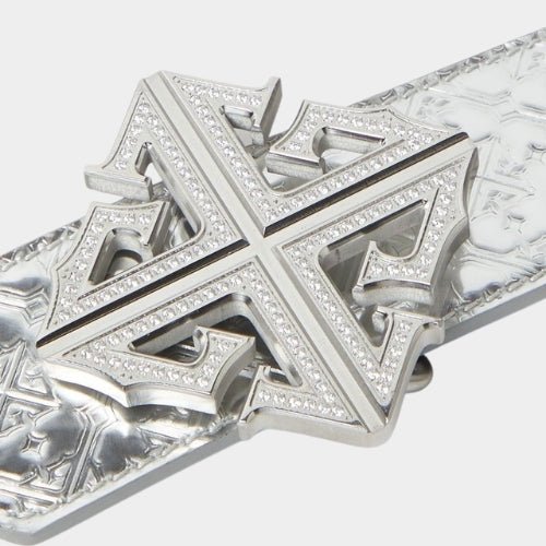 Close-up of crystal-encrusted cross buckle on chrome leather belt