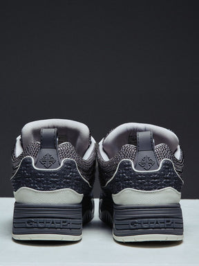 Guapi Cloud Grey Skate Star Sneakers featuring grey and charcoal panels, studded detailing, oversized laces, GUAPI metal hardware, graphic tongue patch, and sculpted sole.