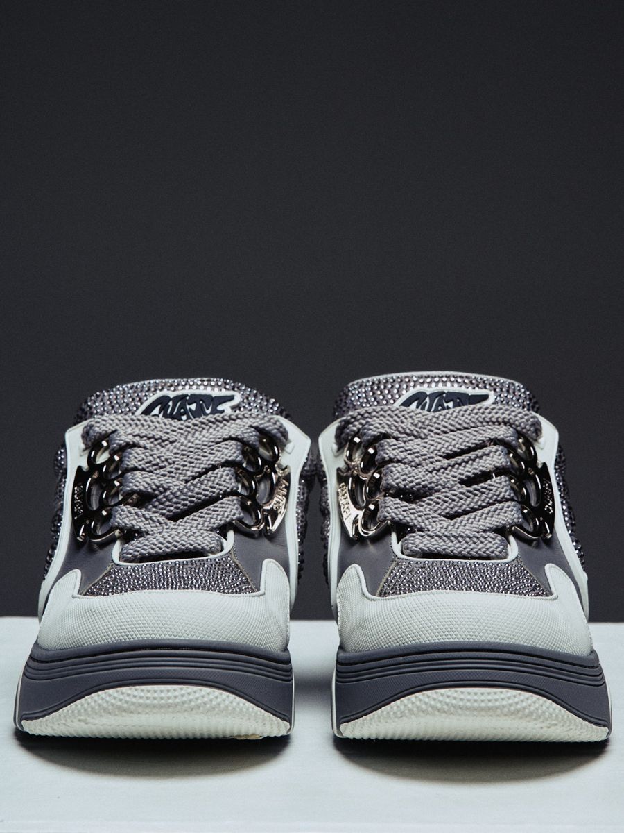 Guapi Cloud Grey Skate Star Sneakers featuring grey and charcoal panels, studded detailing, oversized laces, GUAPI metal hardware, graphic tongue patch, and sculpted sole..