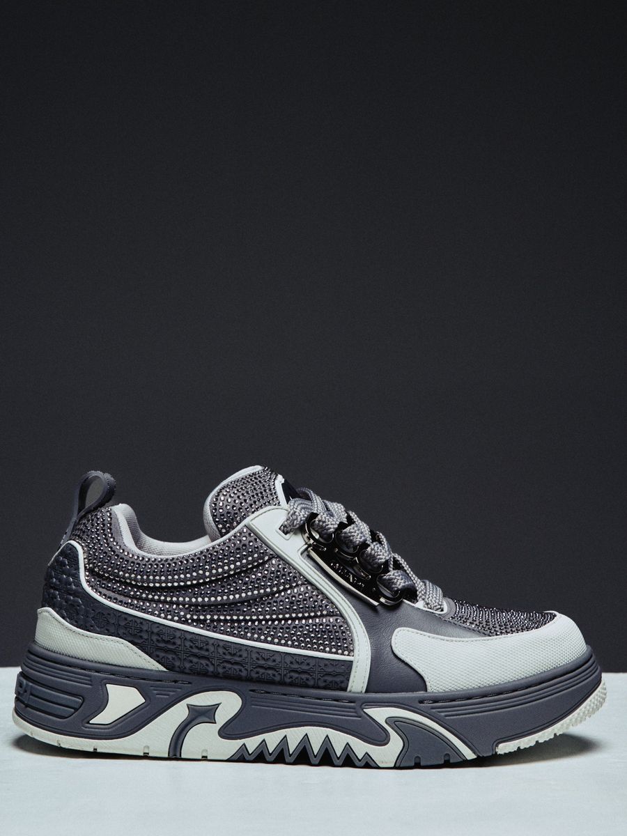 Guapi Cloud Grey Skate Star Sneakers featuring grey and charcoal panels, studded detailing, oversized laces, GUAPI metal hardware, graphic tongue patch, and sculpted sole..