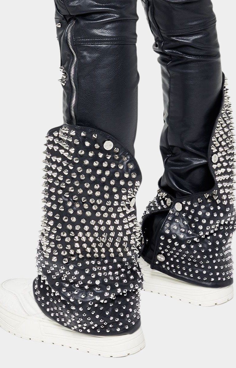 GUAPI logo branding on knee panel of leather pants.