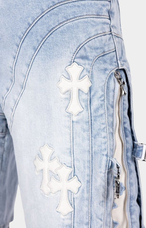 Aqua blue denim shorts featuring signature cross appliqué detailing.