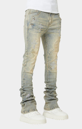 Embroidered cross panel stitching detail on denim.