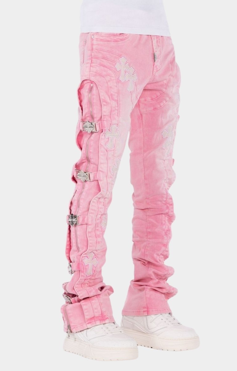 Designer stacked jeans featuring cross patch appliqué artwork.