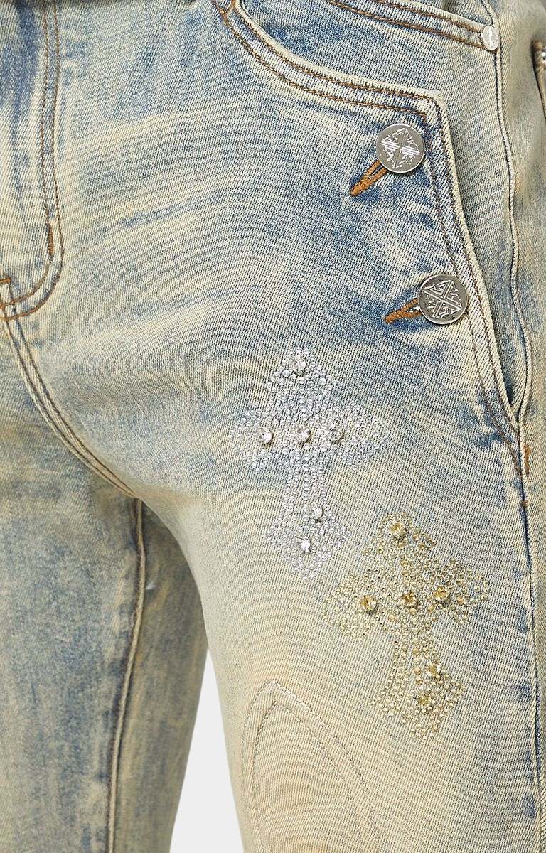 Crystal cross embellishment detail on GUAPI denim.