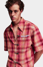 Desert Rose Plaid Shirt - short-sleeve button-up shirt with a pink, red, and orange plaid pattern, featuring decorative metal snap buttons down the front and the brand name 'GUAPI' printed on the chest.