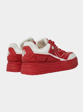 Lifestyle shot of Blood Red Reign sneakers styled with streetwear.