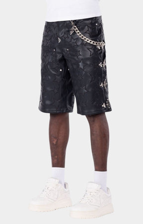 Black leather shorts featuring all-over embossed star detailing with metal chain and buckle design on sides. 