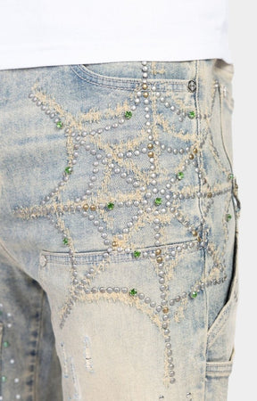 Close-up detail of rhinestone embellishments on Guapi Emerald Spider denim.