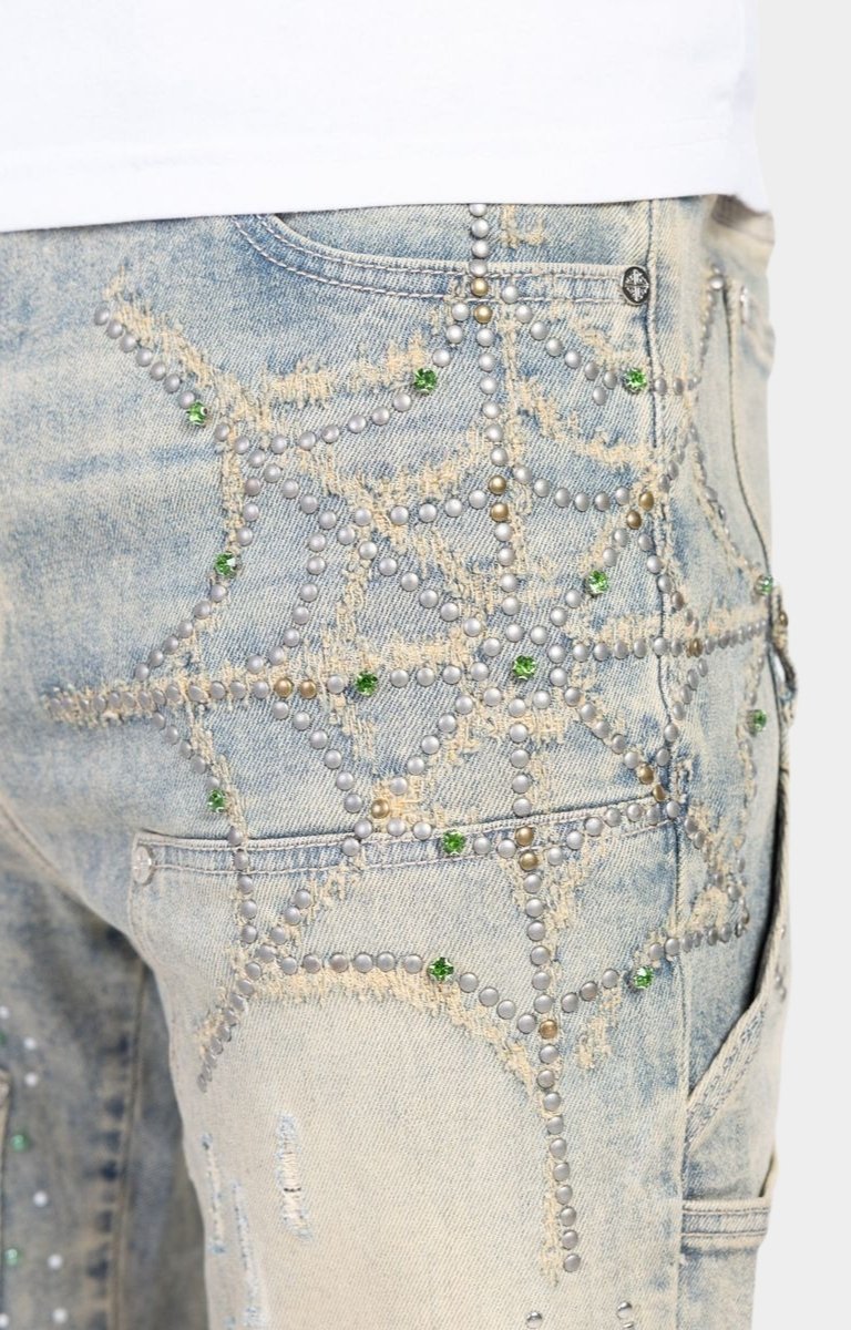 Close-up detail of rhinestone embellishments on Guapi Emerald Spider denim.