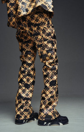 Gold and black Guapi leather pants with plaid graphic design.