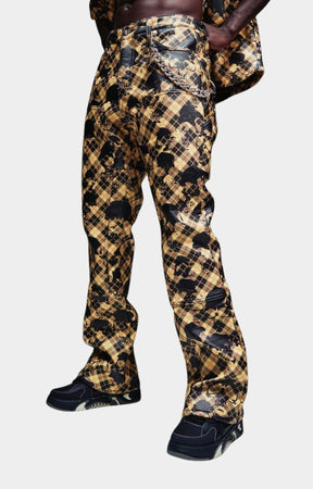 Gold Skull Plaid Leather Pant  featuring a black and tan plaid pattern with glossy black leather paneling on the thighs and a chain detail at the waist.