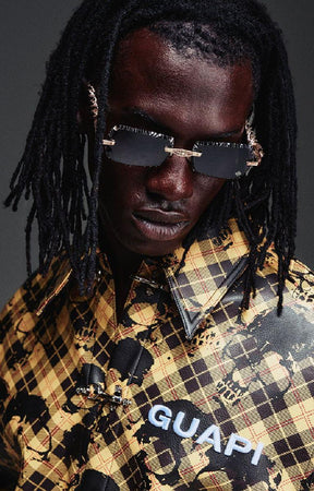 Guapi Gold Skull Plaid Leather Shirt featuring a gold-and-black plaid leather exterior, distressed skull motif, metal toggle closures, chest logo detail and relaxed boxy fit.