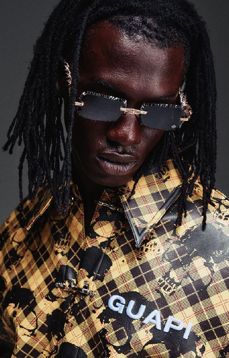 Guapi Gold Skull Plaid Leather Shirt featuring a gold-and-black plaid leather exterior, distressed skull motif, metal toggle closures, chest logo detail and relaxed boxy fit.