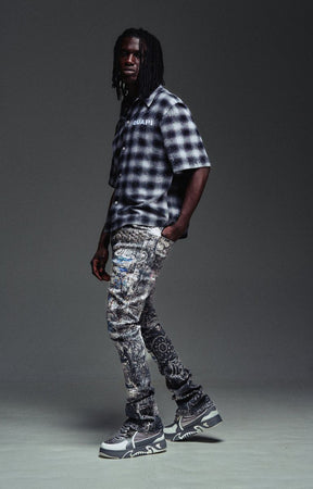 Distressed Guapi Hakai Spider Denim in indigo grey and icy blue tones.