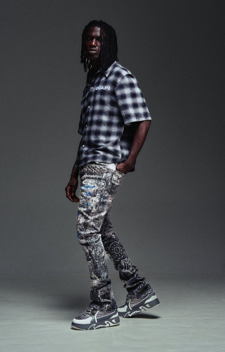 Distressed Guapi Hakai Spider Denim in indigo grey and icy blue tones.