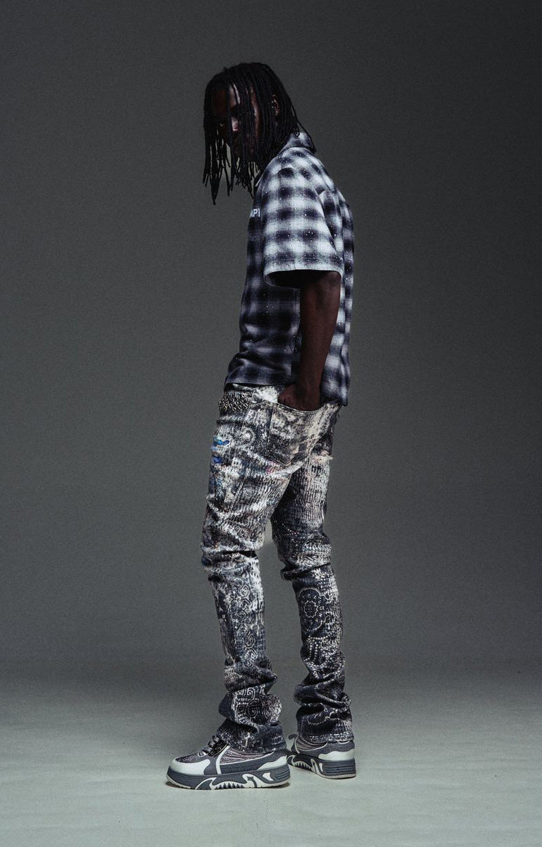 Slim stacked Guapi Hakai Spider jeans with elongated streetwear silhouette.