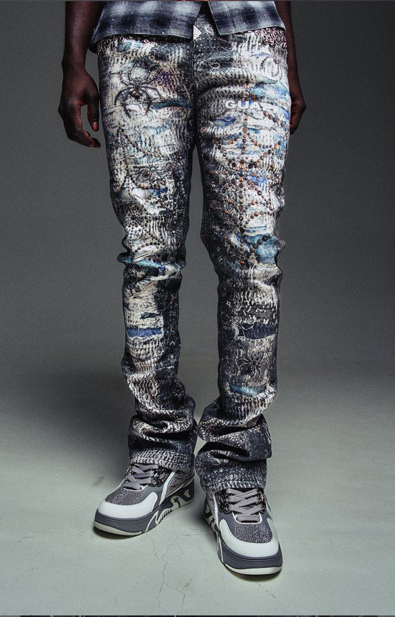 Guapi Hakai Spider statement denim with distressed graphics and stacked legs.