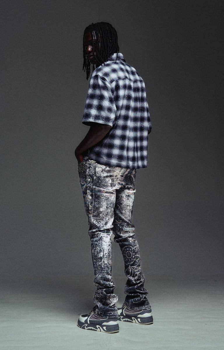 Washed Guapi Hakai graphic denim with layered spider artwork.
