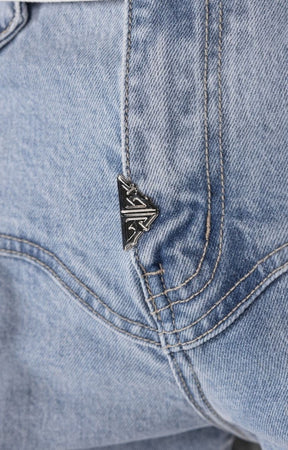 Close-up detail of lace-up lower leg construction on stacked cargo pants.