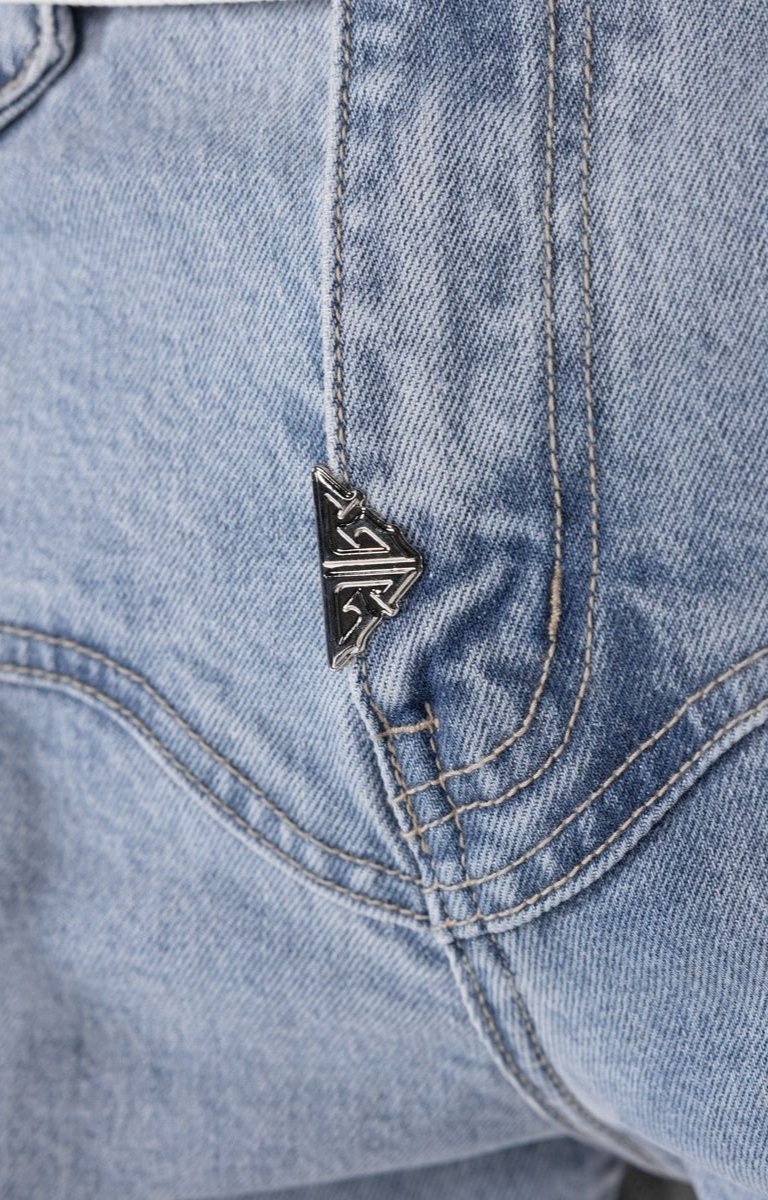 Close-up detail of lace-up lower leg construction on stacked cargo pants.