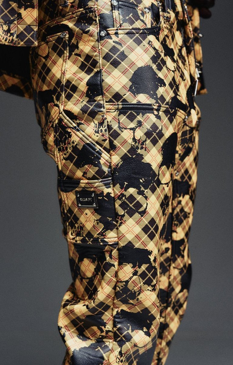 Guapi leather pants with branded hardware and decorative chain detail.