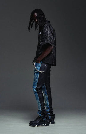 The GUAPI Liquid Black Shirt features an all-over embossed swirl pattern inspired by flowing liquid metal, subtle glossy detailing, and a tonal chest logo. Designed with a relaxed boxy fit, short sleeves, a structured collar, and custom button closures, this statement shirt brings texture and understated shine to contemporary streetwear.