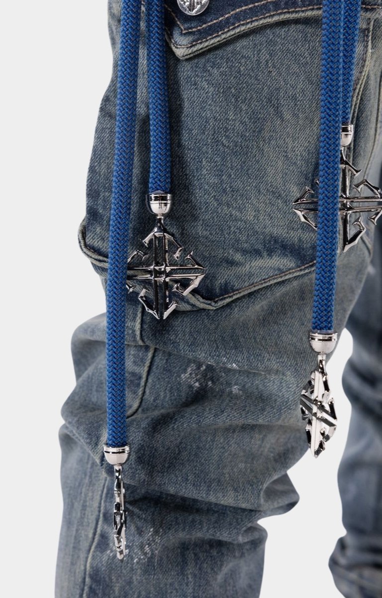 Luxury streetwear cargo jeans featuring distressed details and stacked fit.