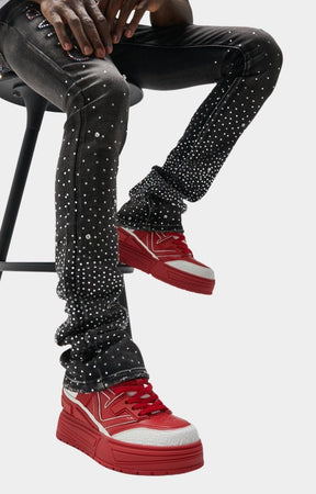 Futuristic red sneakers with chunky outsole and textured grip.