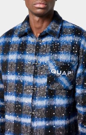 Rhinestone embellishment detail on flannel shirt with guapi mentioned on front pocket. 