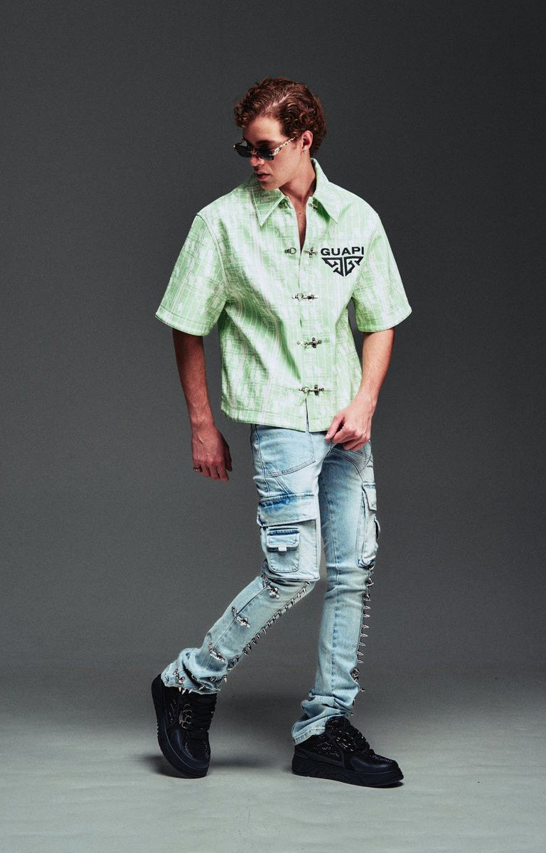 Guapi Mint Glock 17 Textured Leather Shirt featuring an all-over embossed graphic texture, metal toggle closures, structured collar, short sleeves, embroidered GUAPI logo, and relaxed streetwear fit.