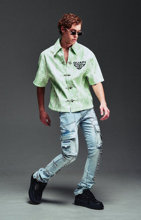 Guapi Mint Glock 17 Textured Leather Shirt featuring an all-over embossed graphic texture, metal toggle closures, structured collar, short sleeves, embroidered GUAPI logo, and relaxed streetwear fit.