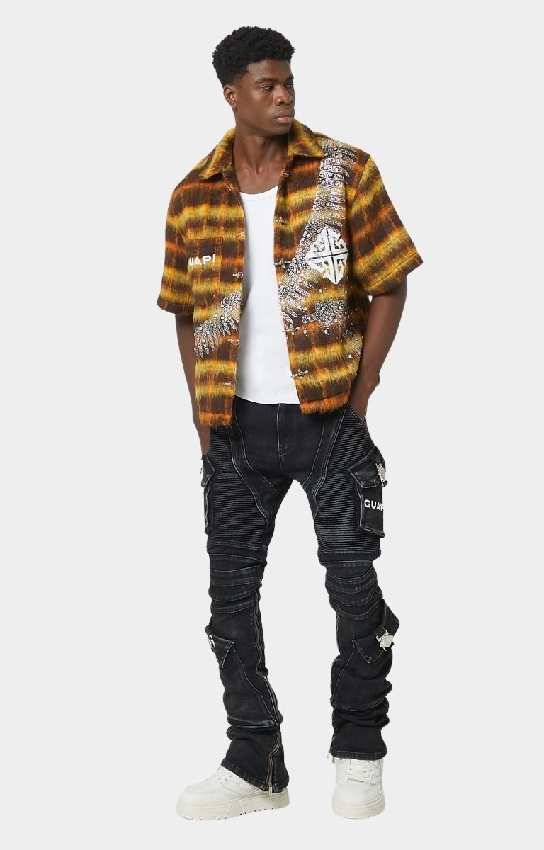 White GUAPI logo print on cargo pocket of biker denim.