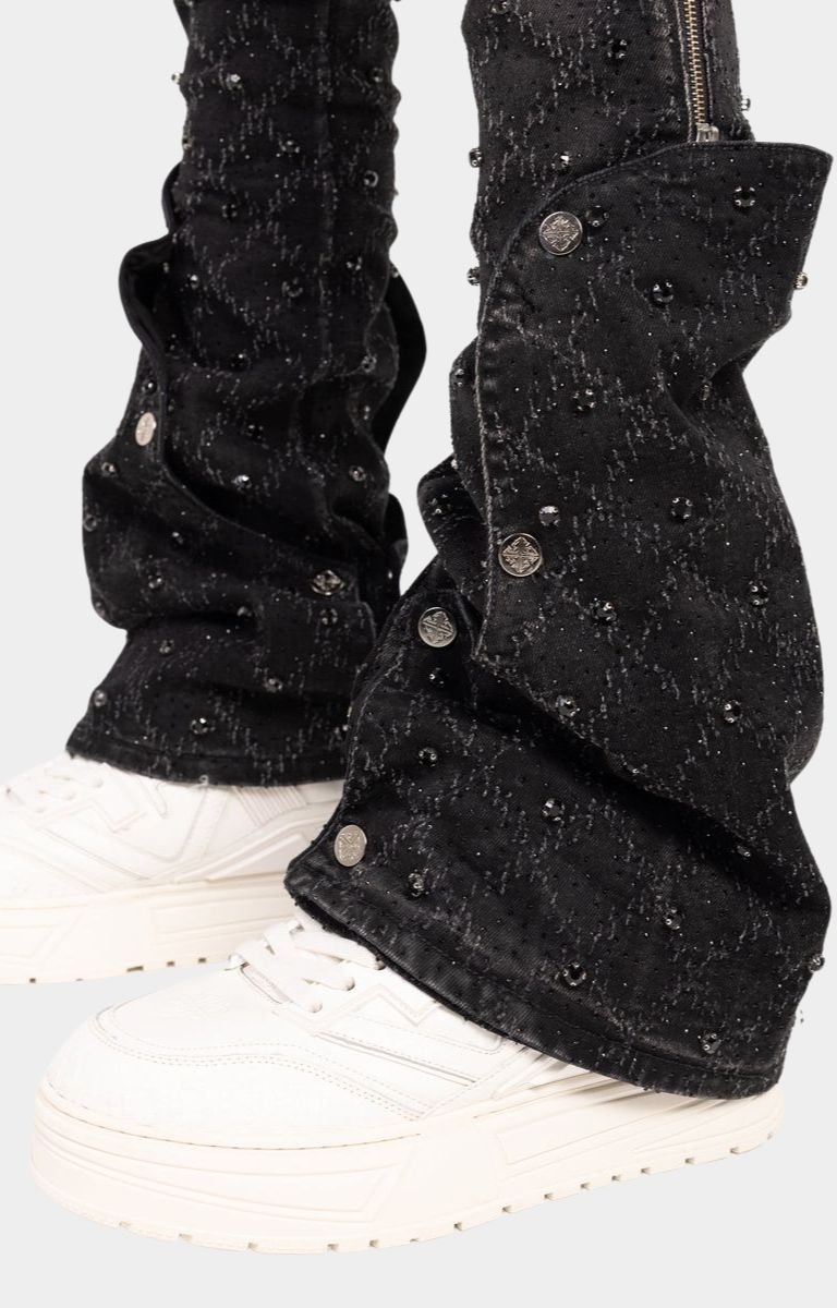 Flared stacked silhouette of guapi black coffin arc embellished stacked denim. 