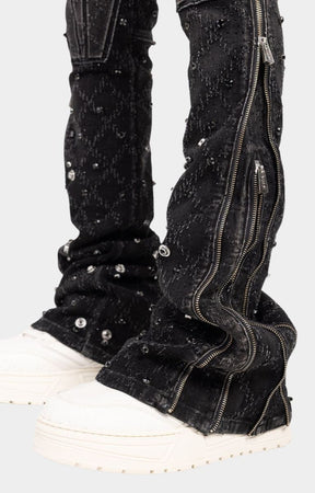Side zipper detail on flared leg of guapi black coffin arc embellished denim. 