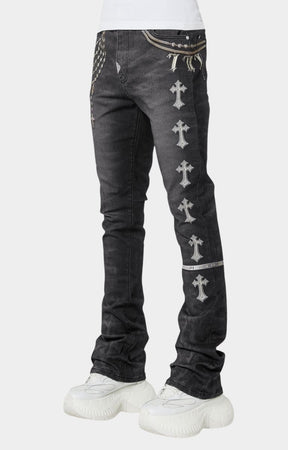 Side view showing rosary and metallic strap prints on Guapi black denim jeans