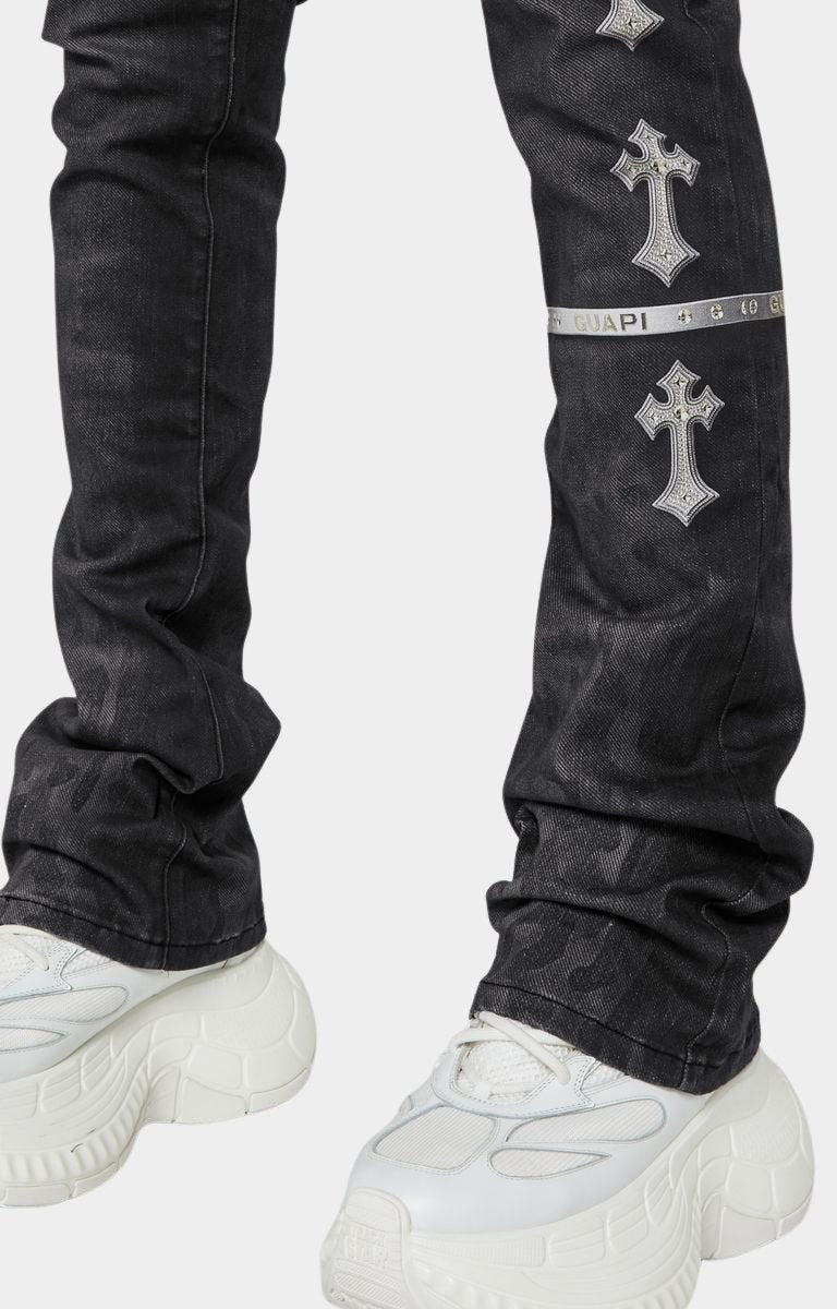 guapi obsidian black heavens vault jeans with silver cross designs withstacked fit silhouette of Guapi black denim with extended inseam