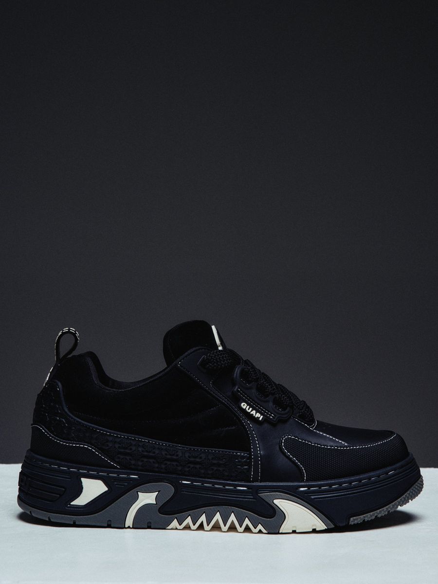 Guapi Obsidian Black Skate Star Sneakers featuring matte leather, embossed geometric detailing, oversized rope laces, padded tongue, chunky sculpted sole, and custom GUAPI branding.
