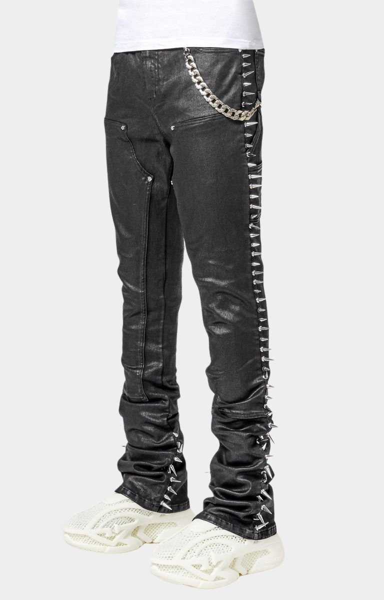 Side profile of black stacked jeans with metal spike detailing