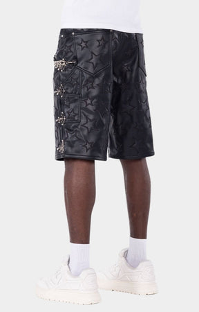 Statement leather shorts with chain accessory and luxury streetwear design.