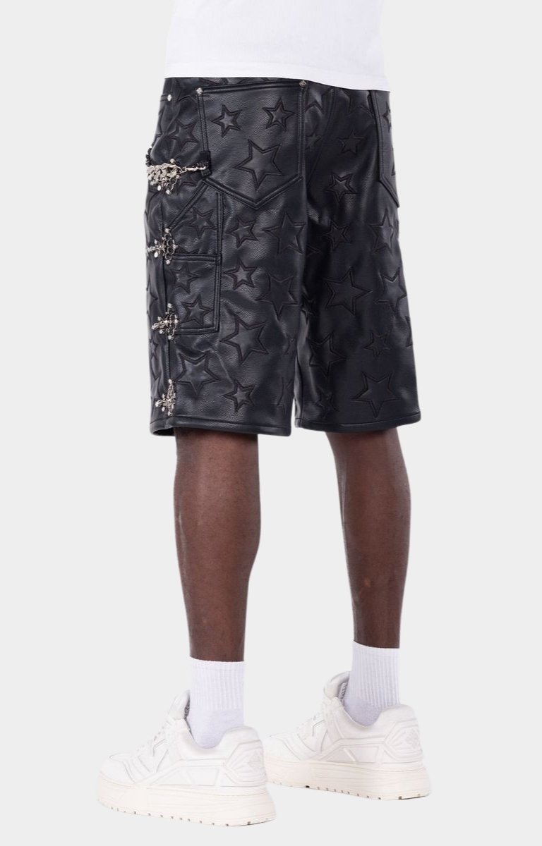 Statement leather shorts with chain accessory and luxury streetwear design.