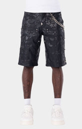 Guapi Obsidian Black Stars leather shorts with embossed star pattern and detachable metal chain.