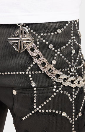 Oversized web detail on upper front of guapi obsidian black waxed spider jeans. 