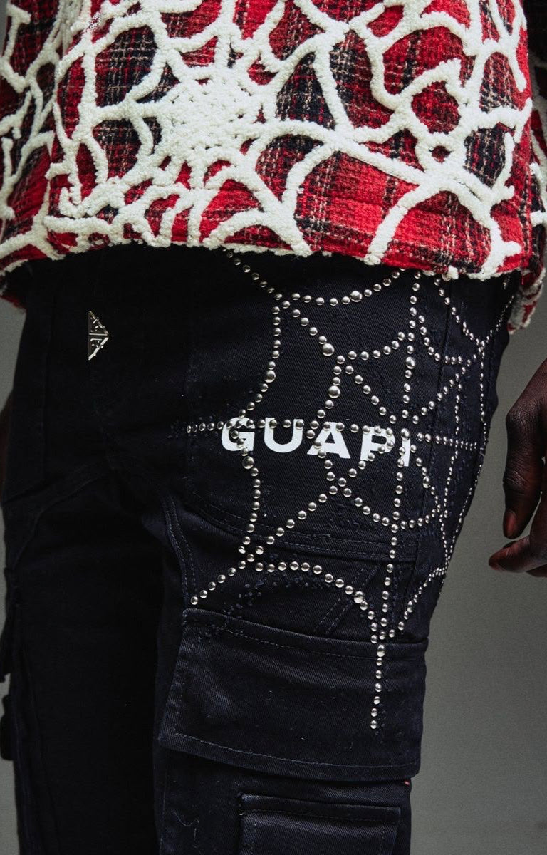 Close-up of Guapi Obsidian Black cargo denim with silver hardware, spider web with rhinestone. 