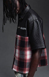 Guapi Obsidian Plaid Aviation Shirt featuring a black textured upper, black and red plaid body, metallic toggle-style closures, pointed collar and short sleeves.