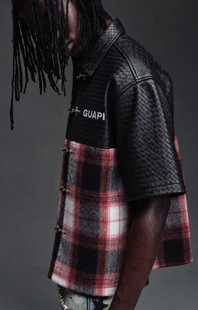 Guapi Obsidian Plaid Aviation Shirt featuring a black textured upper, black and red plaid body, metallic toggle-style closures, pointed collar and short sleeves.