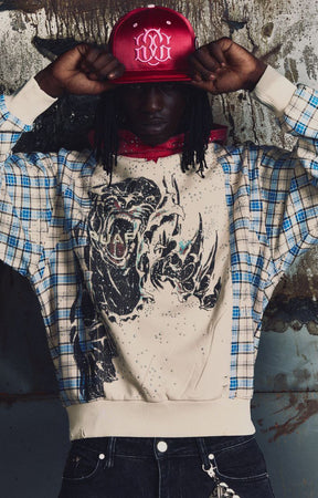 GUAPI Panther Plaid Hoodie featuring a cream body, blue-and-cream plaid panels, red plaid hood, bold panther-inspired back graphic, metallic embellishments, drawstring hood and relaxed fit.
