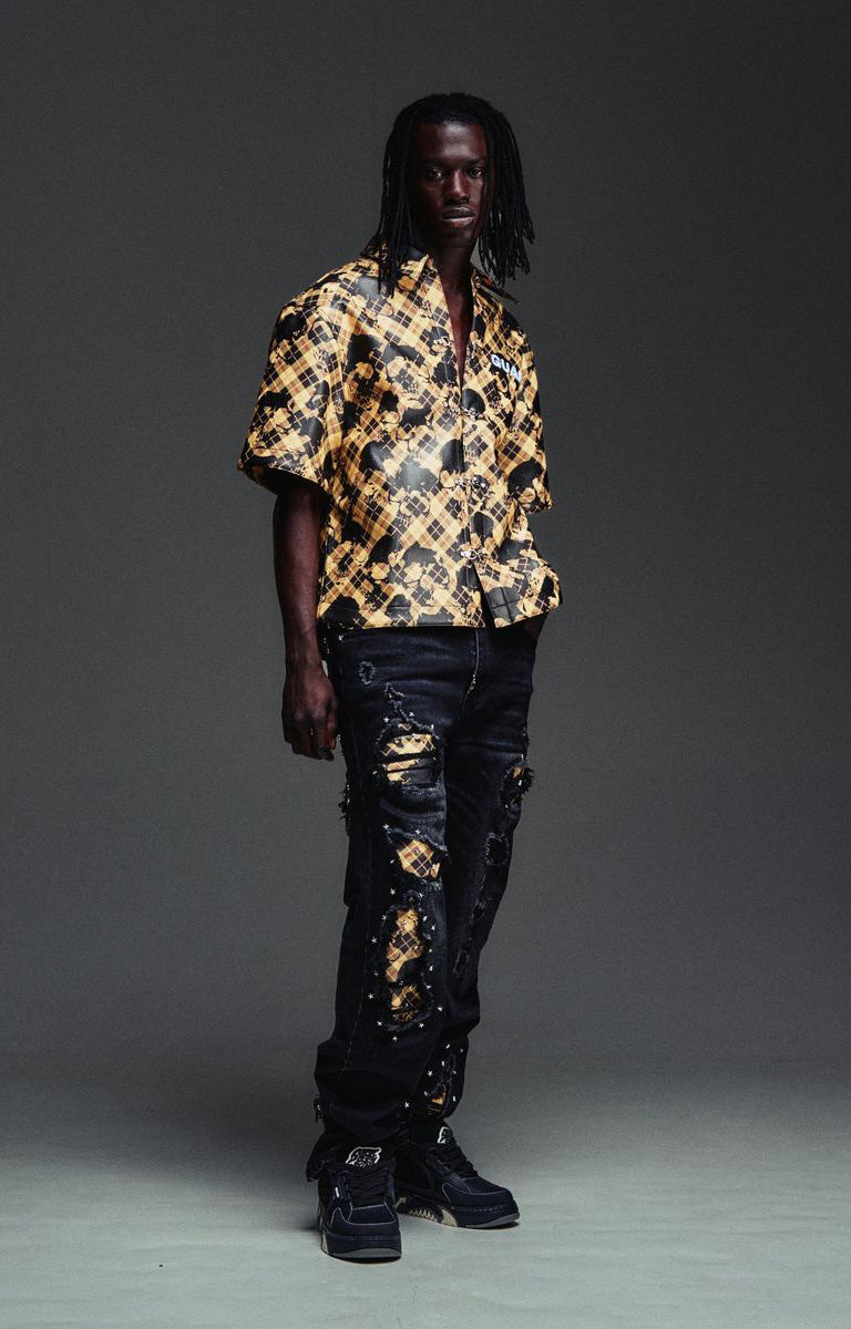 GUAPI Plaid Star Denim with scattered white star embellishments across the black denim legs.
