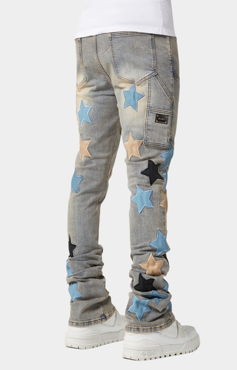 Light-wash denim close-up with vintage fade and leather patches.